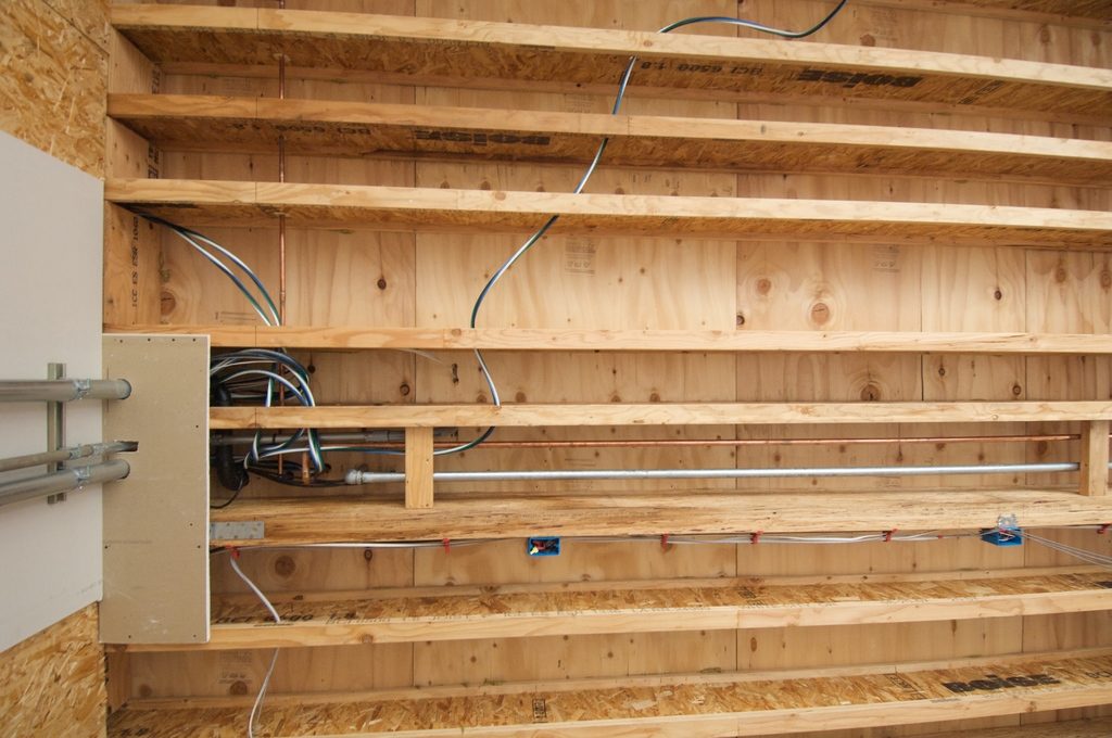 Open garage wall framing with neatly run structured wiring